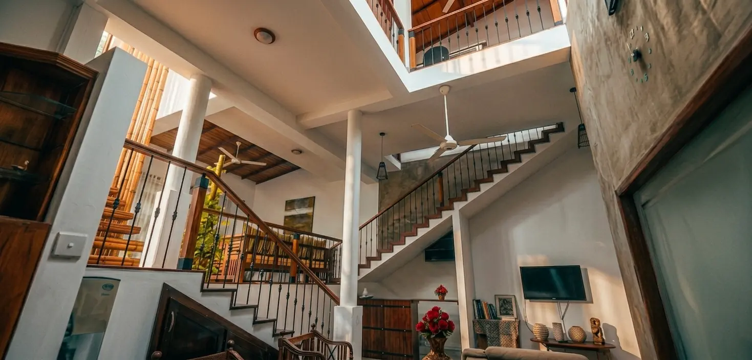 Grand lobby with marble floors and olive trees.